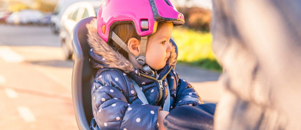 little-girl-with-helmet-on-head-sitting-in-bike-se-2021-08-30-18-53-18-utc-1200x520.jpg