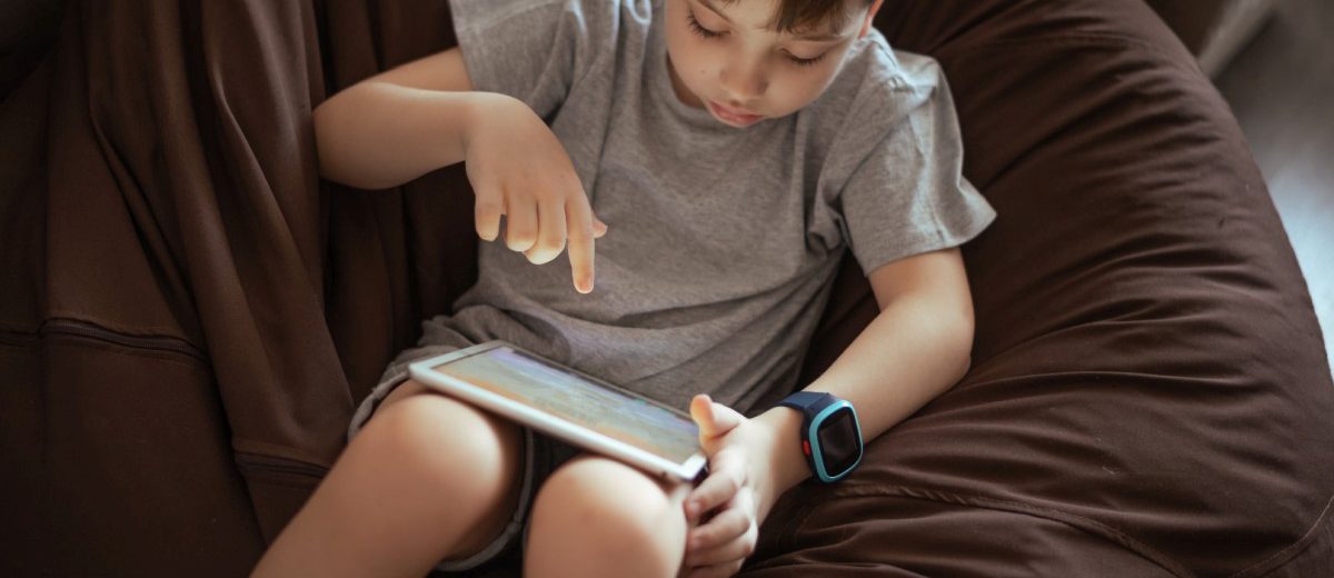 little-kid-boy-using-tablet-sitting-on-the-bean-ba-2022-utc-1-1200x520.jpg