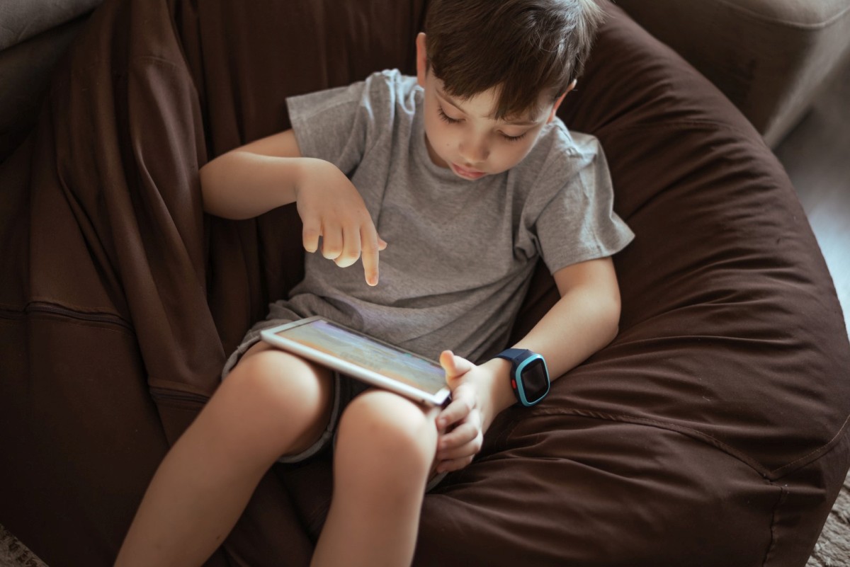 little-kid-boy-using-tablet-sitting-on-the-bean-ba--utc-