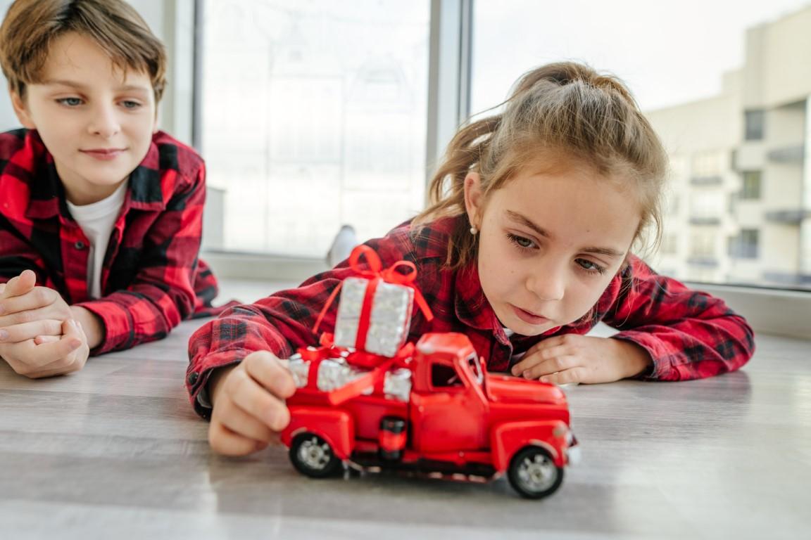 chłopiec i dziewczynka bawiący się samochodzikiem