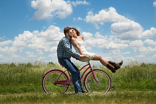 zakochana para na rowerze na łące