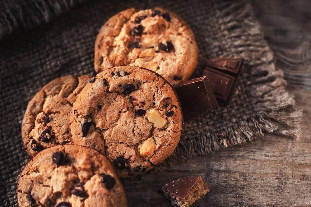 Chocolate chip cookies on dark old wooden table with place for text., freshly baked. Selective Focus with Copy space.