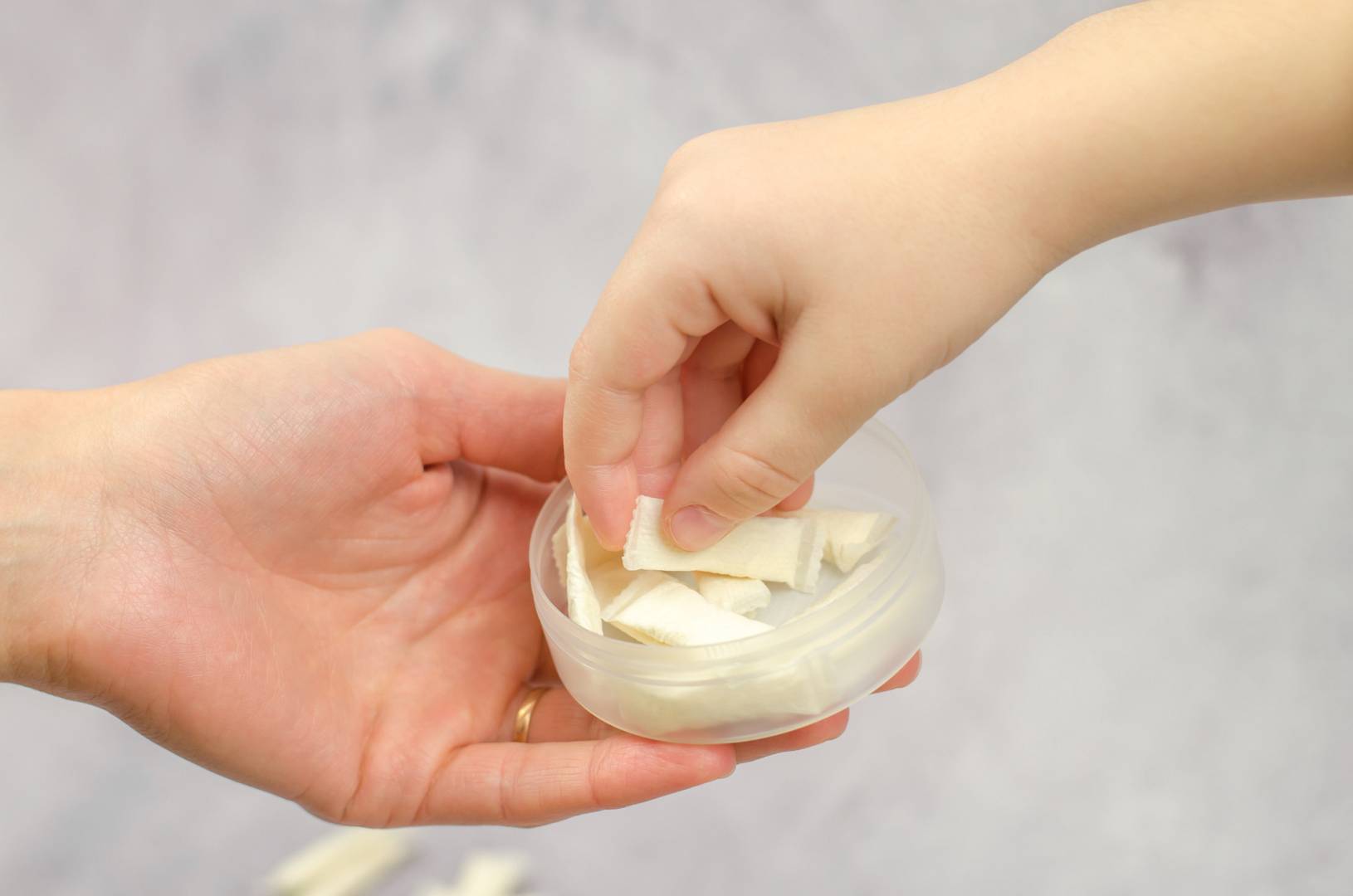 A woman gives Swedish snus to a child, close up