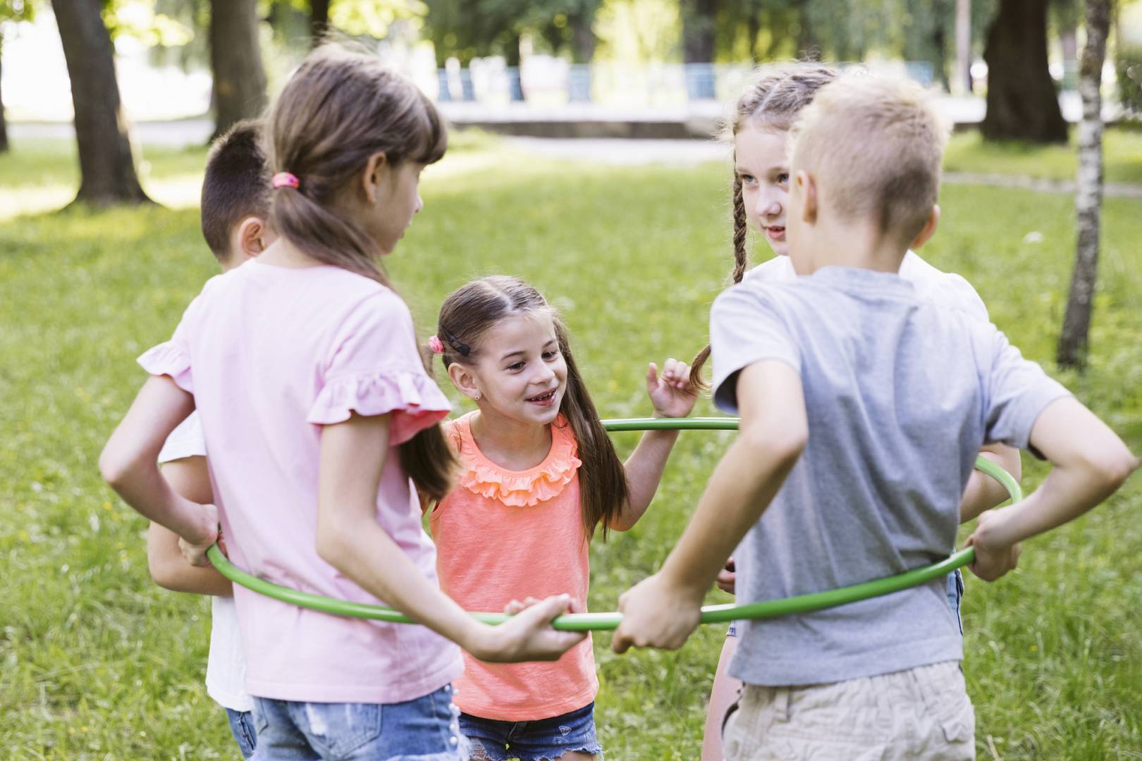 medium shot best friends playing with hula hoop wp