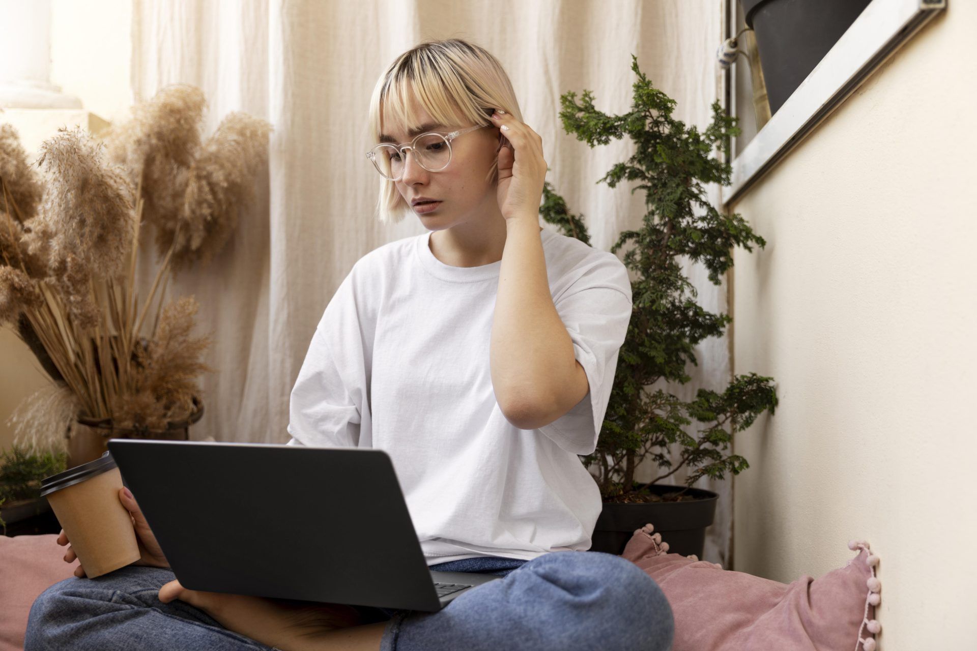 young blonde woman working from home floor