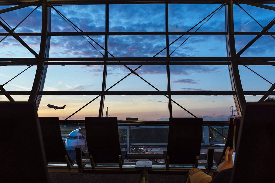 Silhouettes from inside of Airport Terminal. Aircraft Concept.