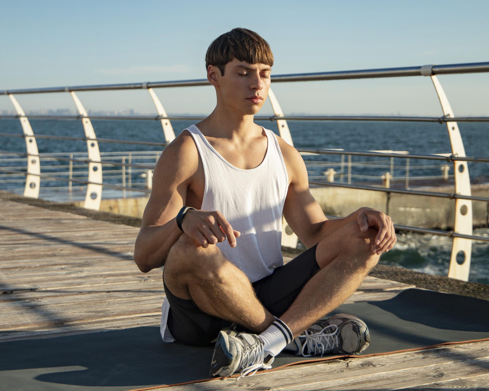 man meditating beach