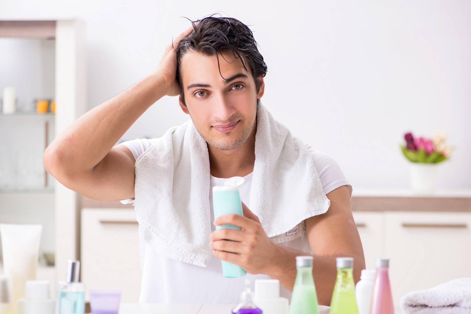 Young handsome man in the bathroom in hygiene concept