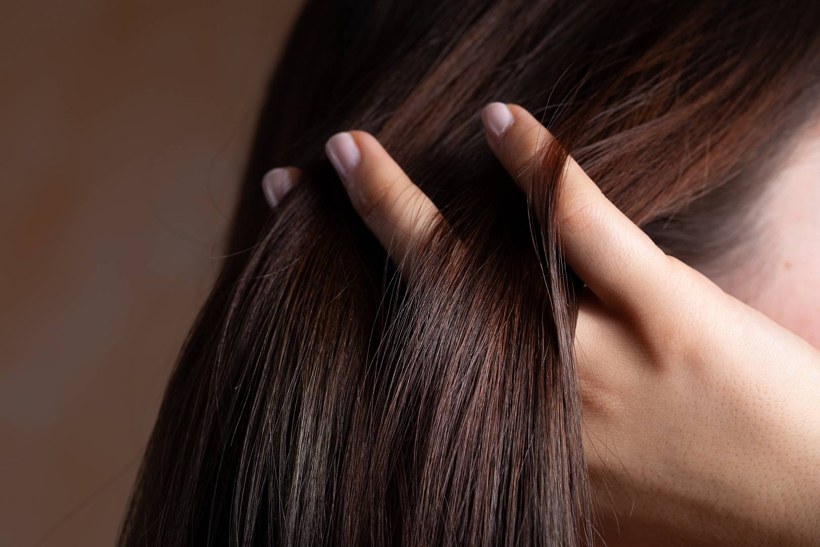 A close up view of a gorgeous young brunette lady with lacquered