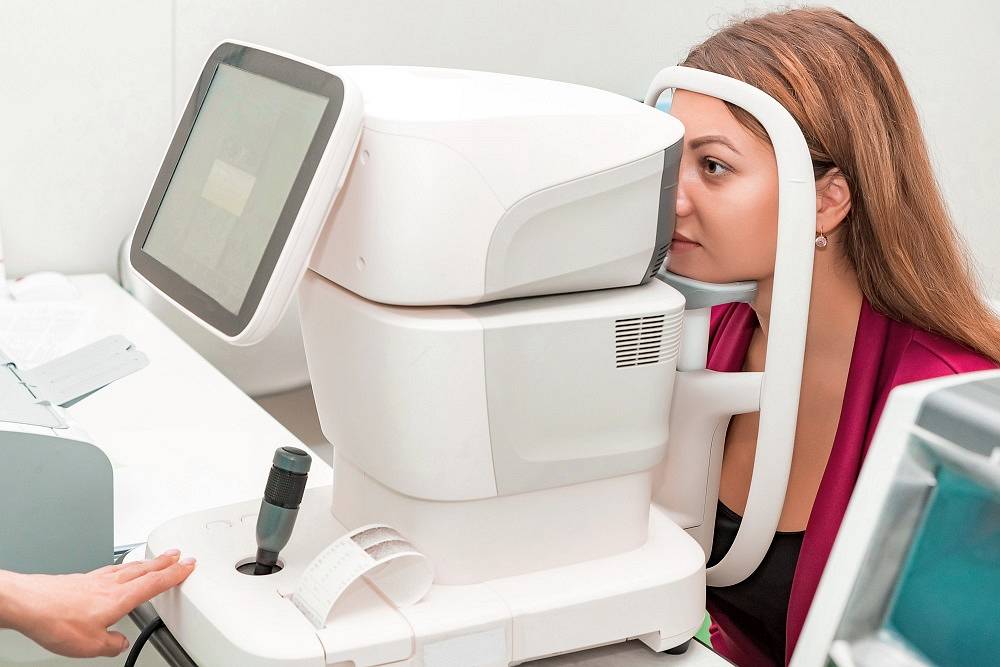 Measuring young woman's eye pressure with tonometer