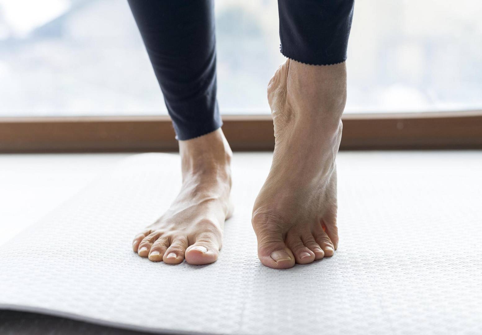 close up legs doing stretching exercises before workout wp