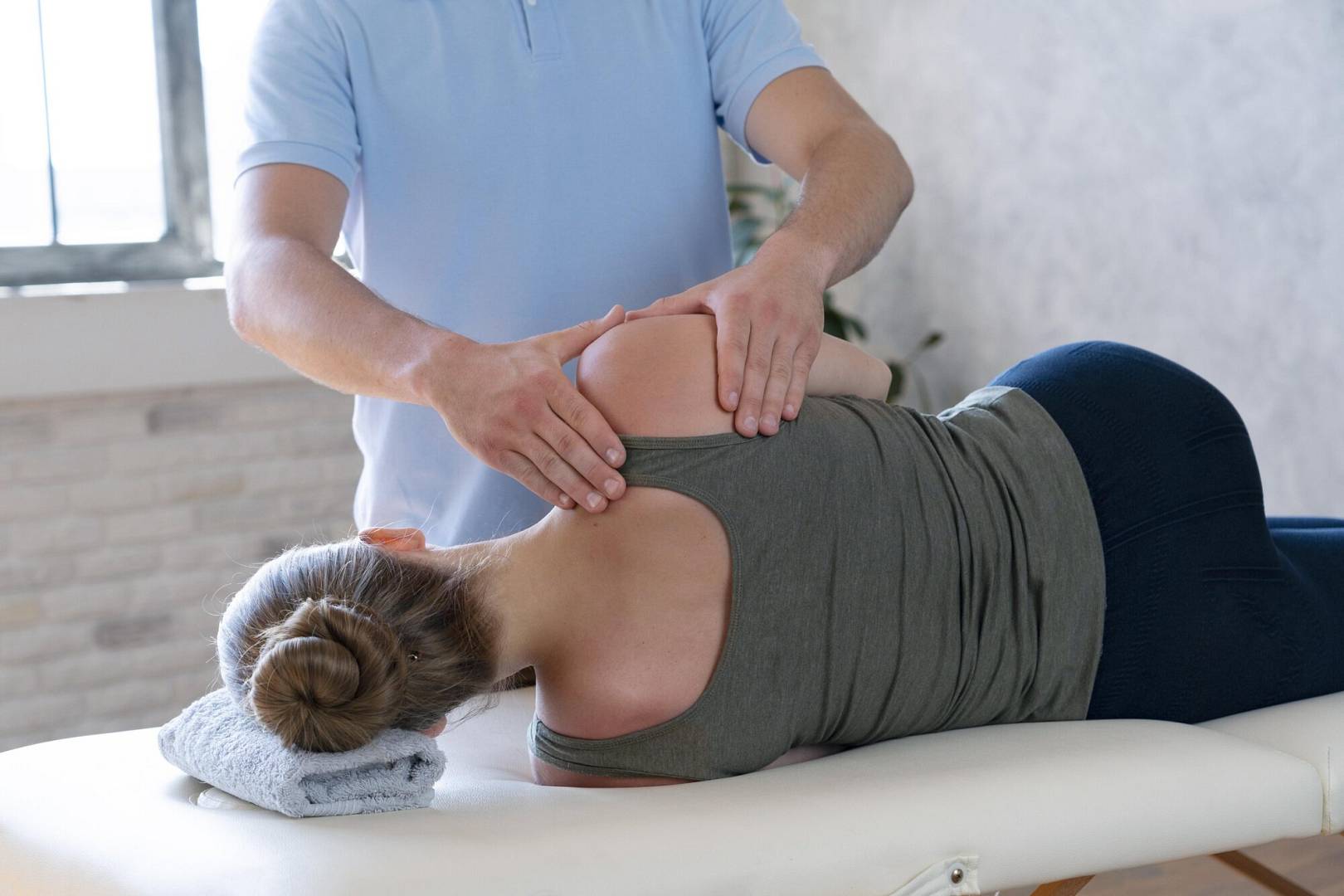 physiotherapist massaging patient close up wp