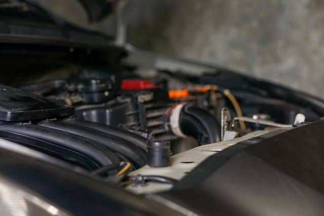 A close up view of a car engine showcasing various components and wiring.