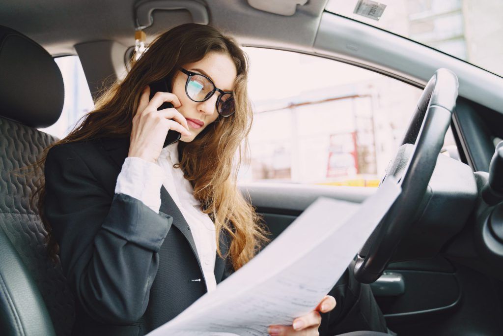 businesswoman sitting inside car