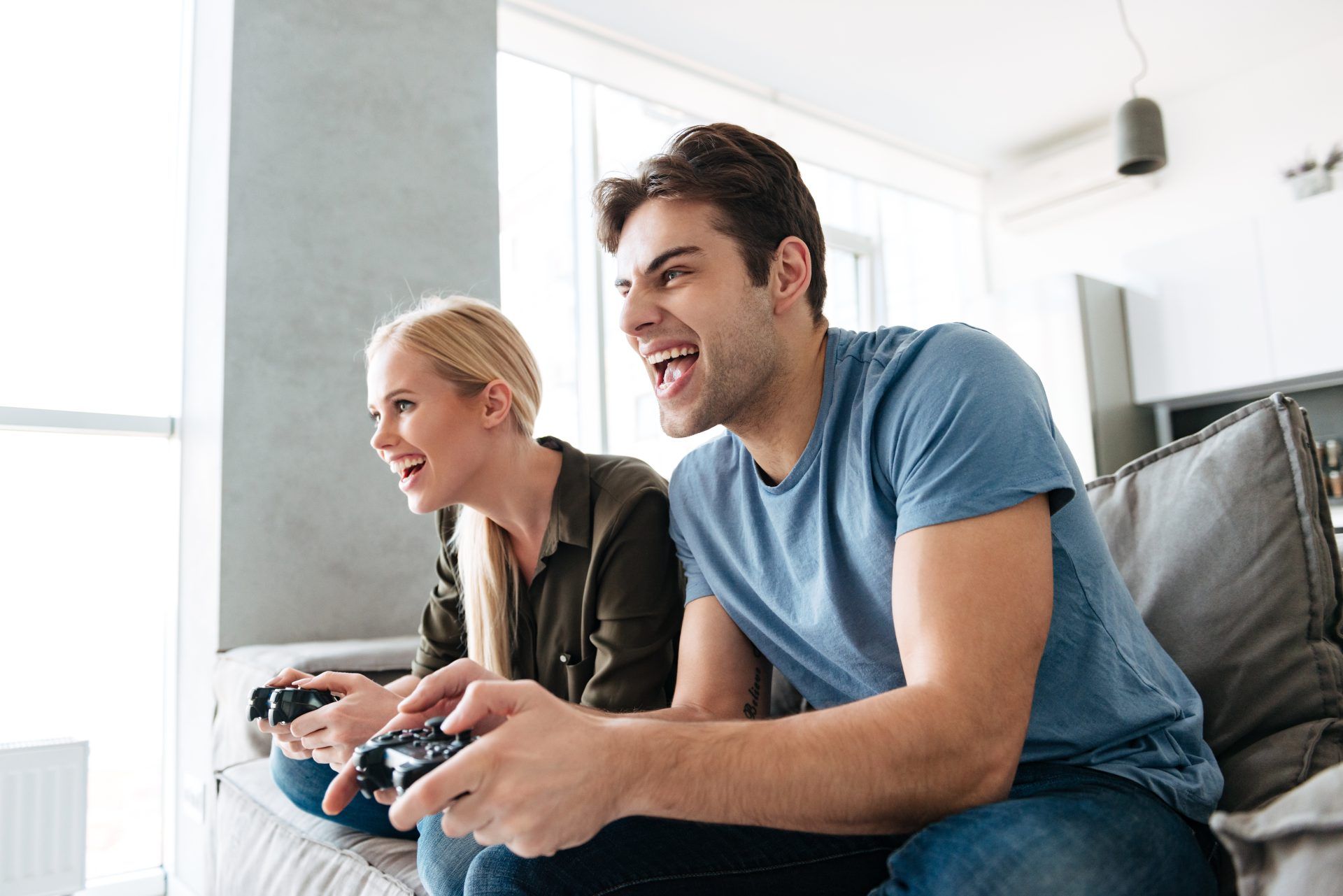 young gambled lovers playing video games home