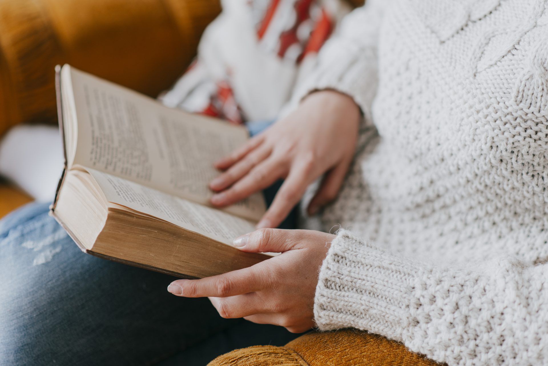 crop woman reading armchair